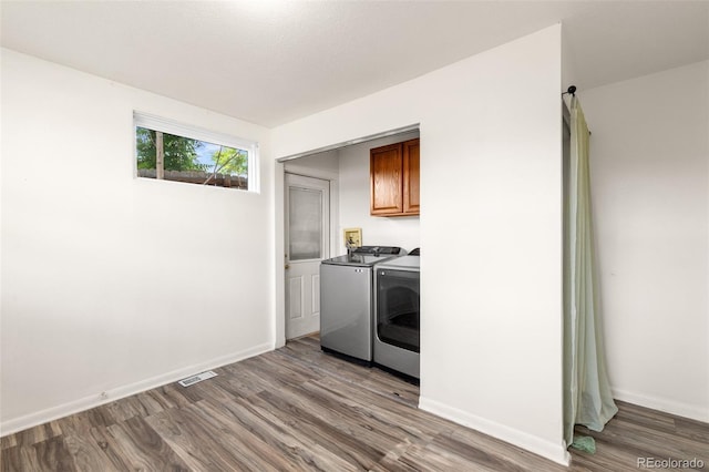 600 Bronco Rd, Denver, CO 80221 - washroom featuring cabinet space, separate washer and dryer, and wood finished floors