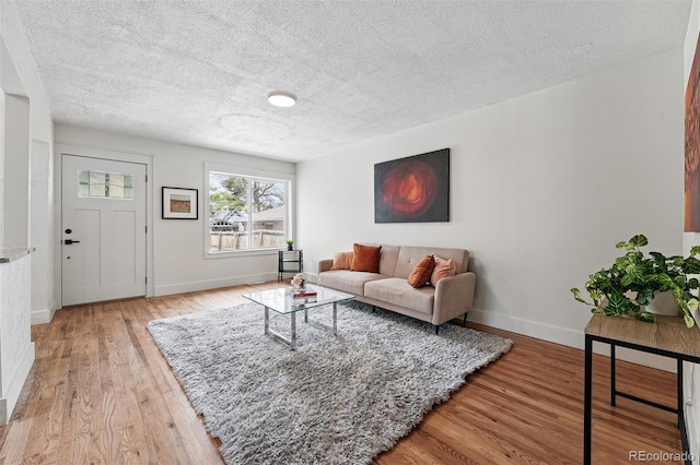 3344 W 33rd Ave, Denver, CO 80211 - living room with a textured ceiling, light wood-type flooring, and baseboards