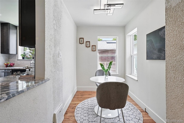 3344 W 33rd Ave, Denver, CO 80211 - living area with light wood-style flooring, baseboards, and a textured wall
