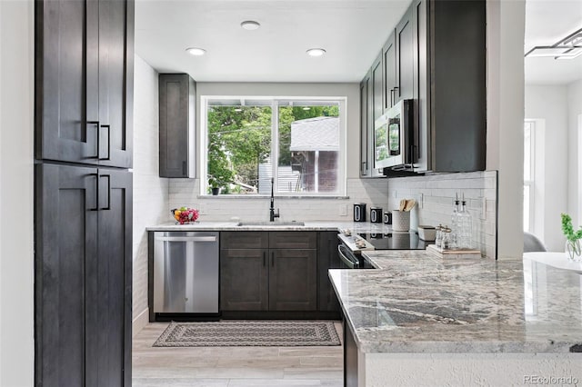 3344 W 33rd Ave, Denver, CO 80211 - kitchen featuring stainless steel appliances, a sink, light stone counters, and recessed lighting