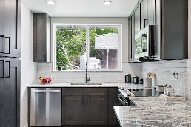 3344 W 33rd Ave, Denver, CO 80211 - kitchen with appliances with stainless steel finishes, a sink, light stone counters, decorative backsplash, and recessed lighting