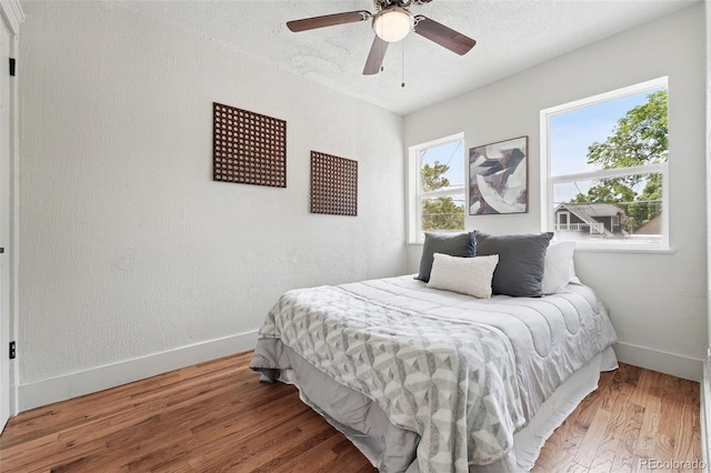 3344 W 33rd Ave, Denver, CO 80211 - bedroom featuring baseboards, wood finished floors, a ceiling fan, and a textured ceiling