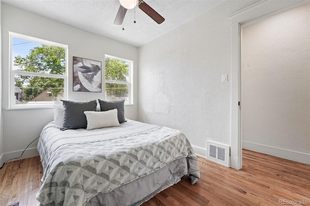 3344 W 33rd Ave, Denver, CO 80211 - bedroom with baseboards, wood finished floors, a textured wall, and ceiling fan