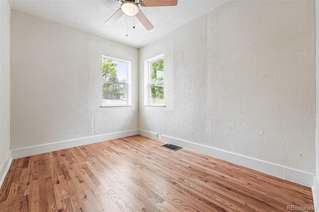 3344 W 33rd Ave, Denver, CO 80211 - empty room featuring light wood-type flooring, a textured wall, baseboards, and ceiling fan