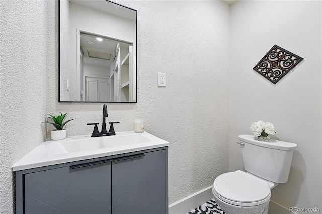 3344 W 33rd Ave, Denver, CO 80211 - bathroom with vanity, toilet, baseboards, and a textured wall