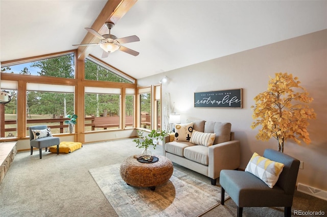 carpeted living room with ceiling fan and lofted ceiling with beams