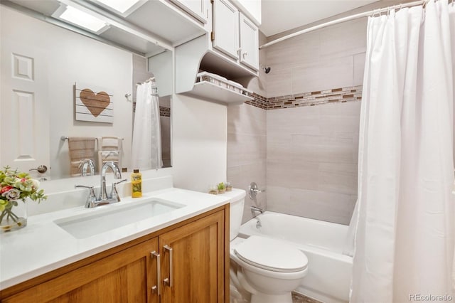 full bathroom featuring vanity, shower / bath combination with curtain, and toilet