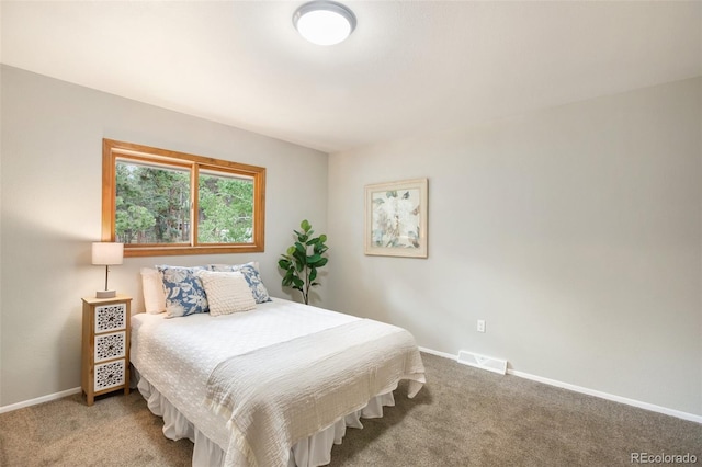 carpeted bedroom featuring visible vents and baseboards