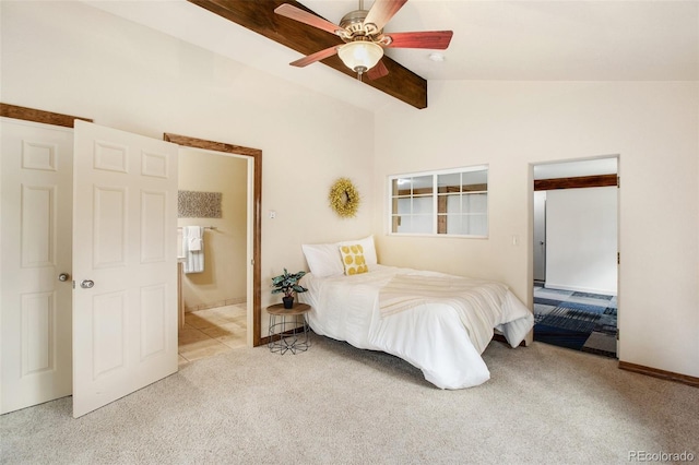 bedroom featuring a ceiling fan, carpet, vaulted ceiling with beams, and ensuite bathroom