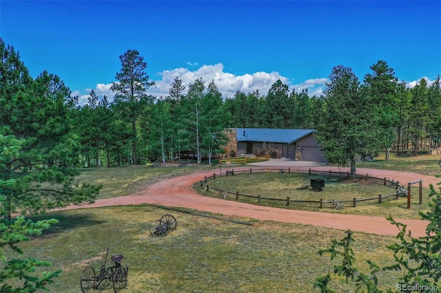 view of community featuring a rural view and a lawn