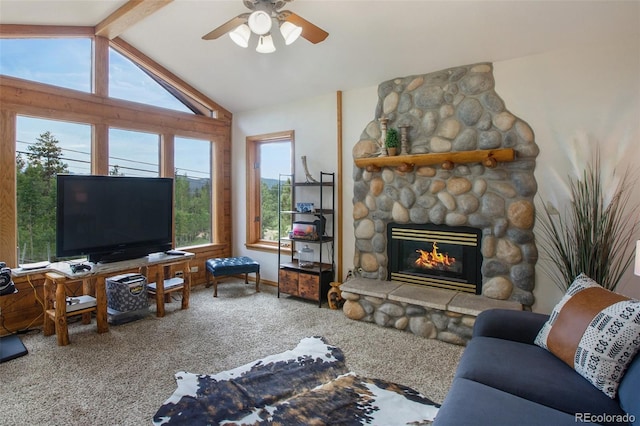 living area with vaulted ceiling with beams, carpet, a fireplace, and a ceiling fan