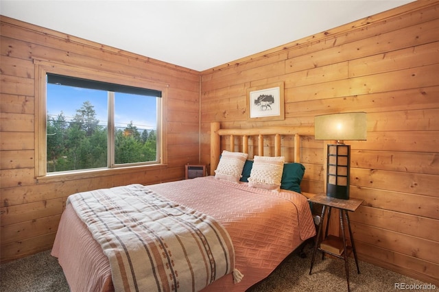 bedroom featuring wood walls and carpet