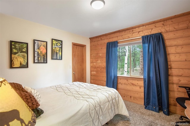 bedroom featuring wood walls and carpet flooring