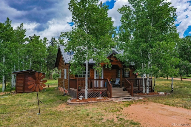 view of front of home featuring a front yard and a shed