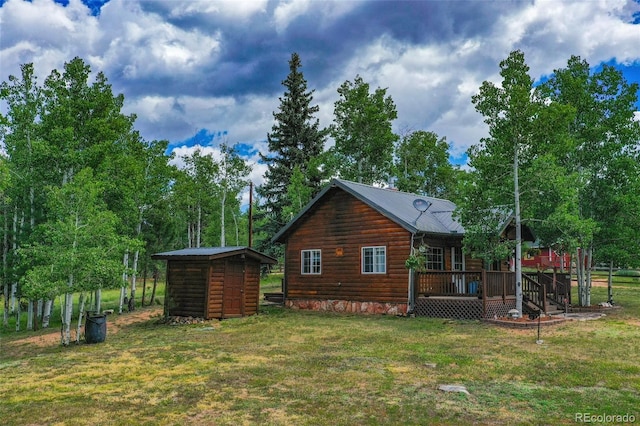 exterior space with an outbuilding, stairs, a storage unit, a deck, and a yard