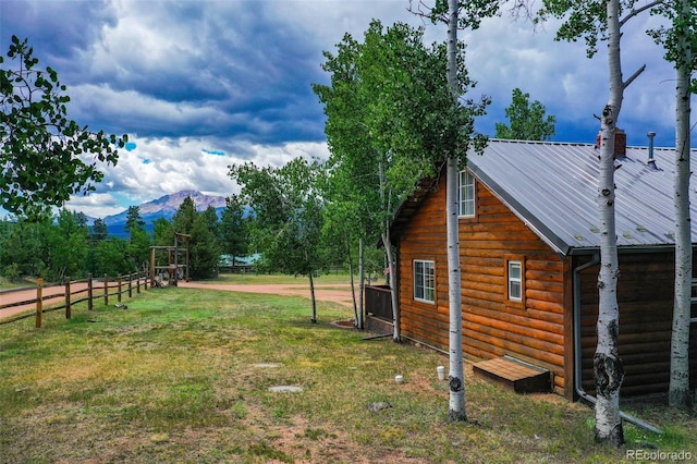 view of yard with fence and a mountain view