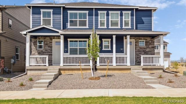 view of front of property with stone siding and covered porch