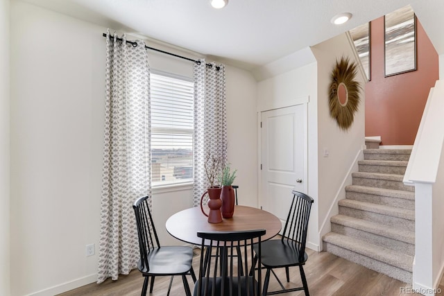 dining room featuring stairway, recessed lighting, light wood-style flooring, and baseboards