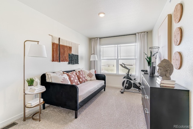 carpeted living room with baseboards and visible vents