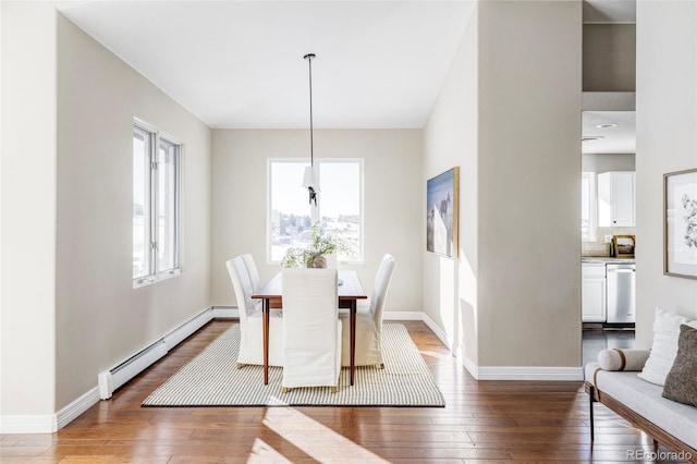 dining space featuring dark wood-type flooring and a baseboard radiator