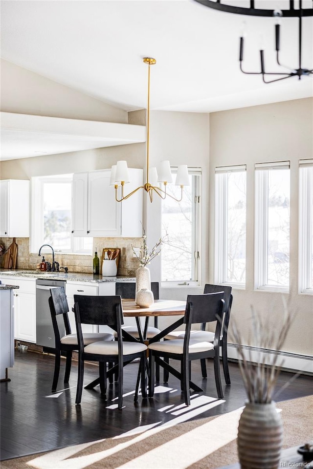 dining room featuring dark hardwood / wood-style flooring, a baseboard radiator, and a chandelier