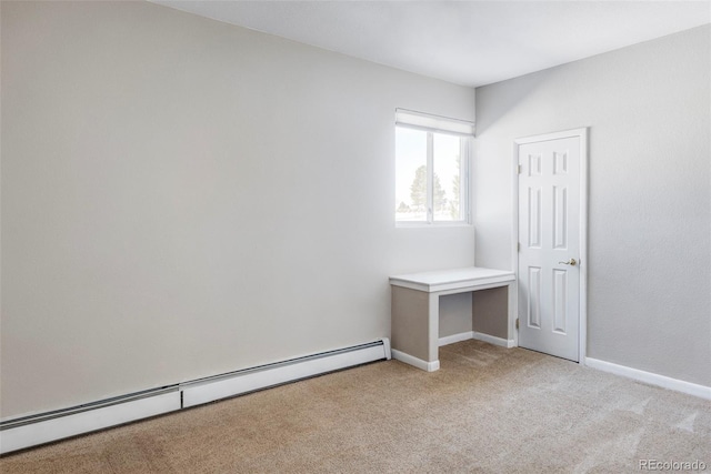 unfurnished bedroom with light colored carpet and baseboard heating