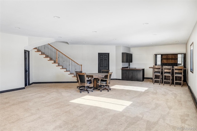 dining room featuring light carpet