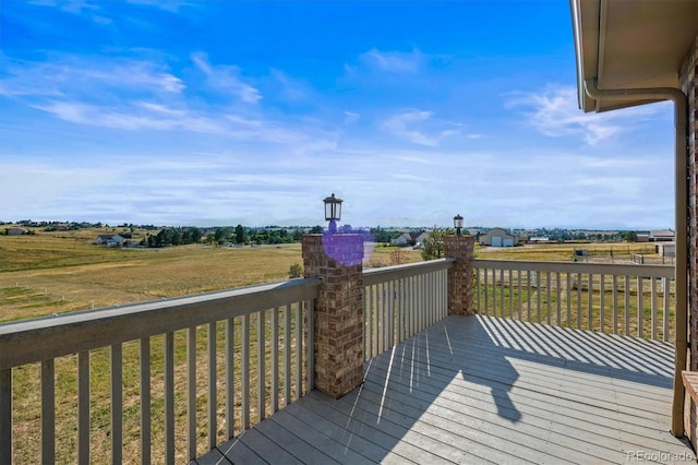 wooden deck featuring a rural view