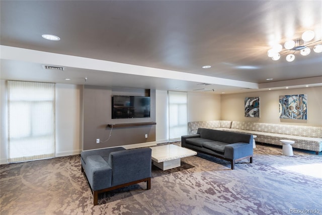 carpeted living room featuring baseboards, visible vents, and recessed lighting