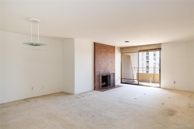 unfurnished living room featuring carpet flooring and a fireplace