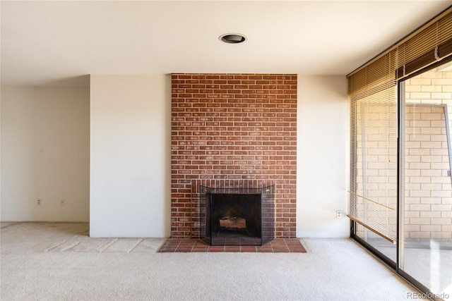 unfurnished living room with carpet and a fireplace