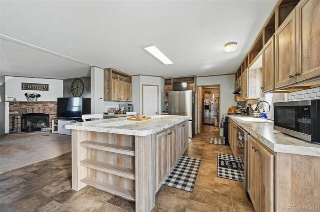 30890 Ken Vw, Yoder, CO 80864 - kitchen featuring open shelves, appliances with stainless steel finishes, light countertops, a center island, and a sink