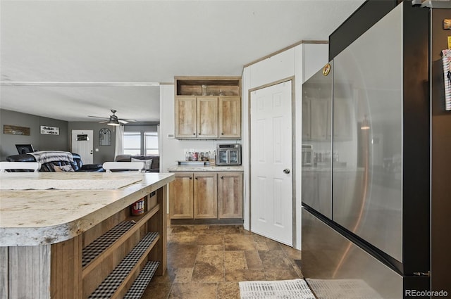 30890 Ken Vw, Yoder, CO 80864 - kitchen featuring freestanding refrigerator, dark stone finish flooring, light countertops, a ceiling fan, and open floor plan