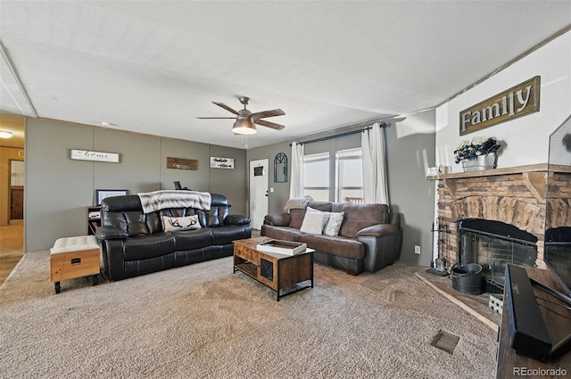30890 Ken Vw, Yoder, CO 80864 - carpeted living room featuring a ceiling fan and a fireplace with raised hearth