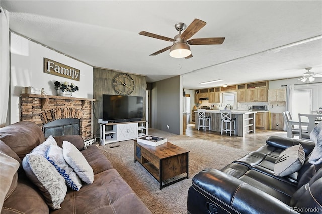 30890 Ken Vw, Yoder, CO 80864 - living area with ceiling fan, healthy amount of natural light, and a stone fireplace