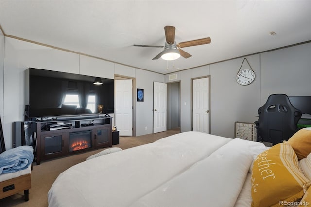 30890 Ken Vw, Yoder, CO 80864 - bedroom featuring carpet flooring, a glass covered fireplace, and ceiling fan