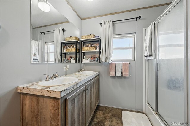 30890 Ken Vw, Yoder, CO 80864 - full bathroom featuring healthy amount of natural light, an enclosed shower, double vanity, and stone finish flooring