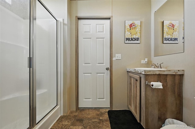 30890 Ken Vw, Yoder, CO 80864 - bathroom featuring vanity, a shower with shower door, and stone finish flooring
