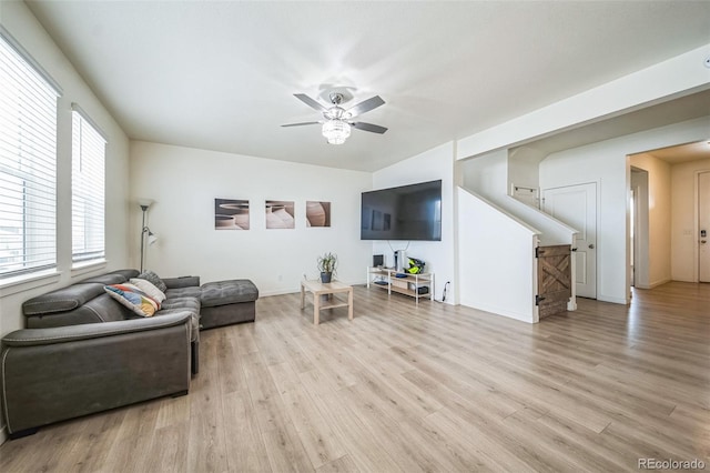 living room with light hardwood / wood-style floors and ceiling fan