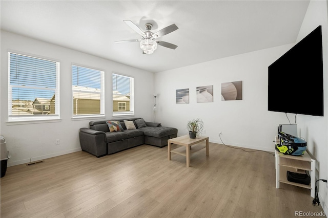 living room with ceiling fan and light hardwood / wood-style flooring