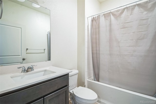 full bathroom featuring vanity, shower / bath combination with curtain, and toilet