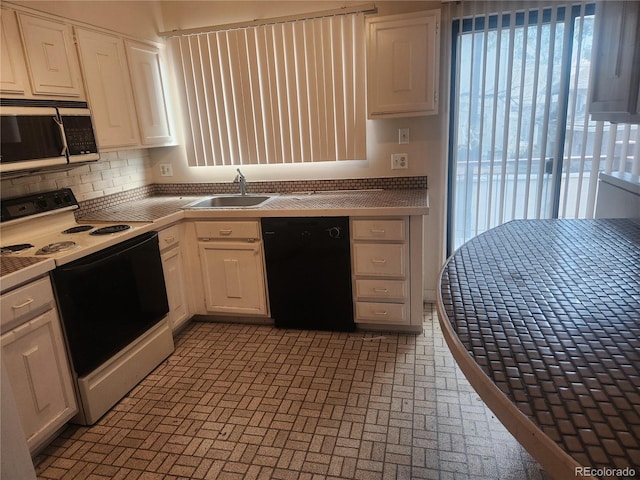805 E 7th Ave Unit 8, Denver, CO 80218 - kitchen with electric range, black dishwasher, a sink, and plenty of natural light