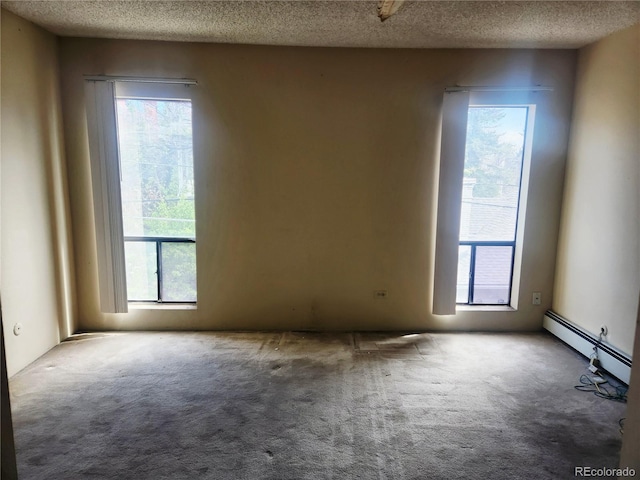 805 E 7th Ave Unit 8, Denver, CO 80218 - carpeted empty room featuring a textured ceiling, healthy amount of natural light, and a baseboard radiator