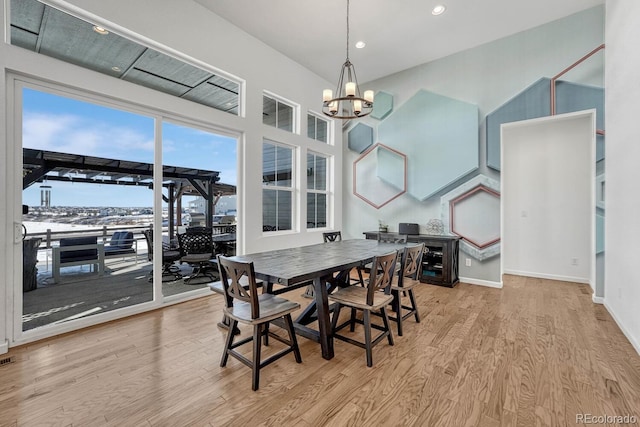 dining room featuring light hardwood / wood-style floors and an inviting chandelier