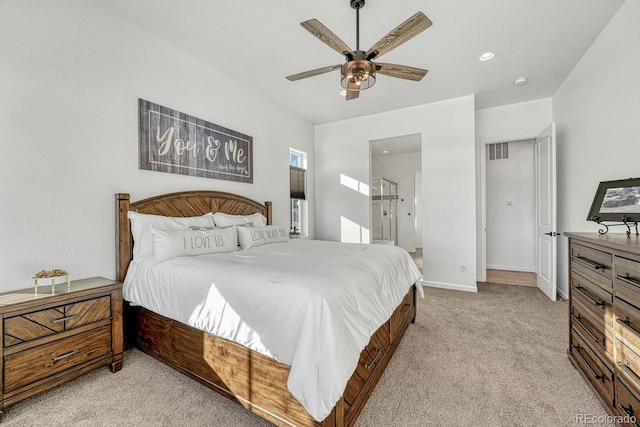 carpeted bedroom with ceiling fan and ensuite bathroom