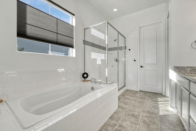 bathroom with tile patterned flooring, vanity, plenty of natural light, and independent shower and bath