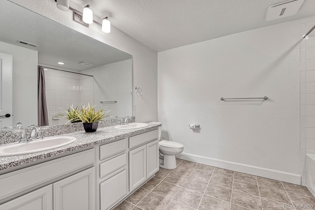 full bathroom featuring tile patterned flooring, vanity, a textured ceiling, and toilet