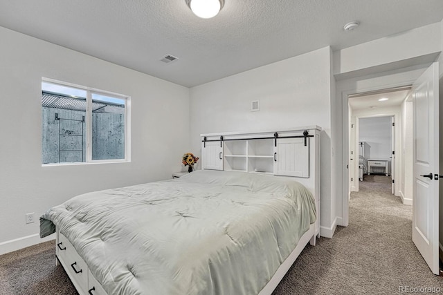 carpeted bedroom with a textured ceiling