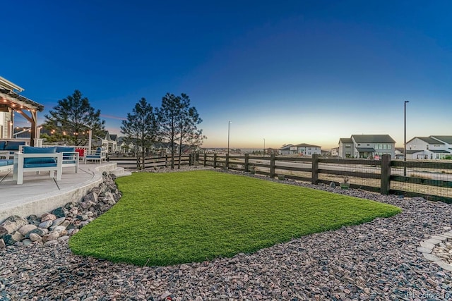 view of yard at dusk