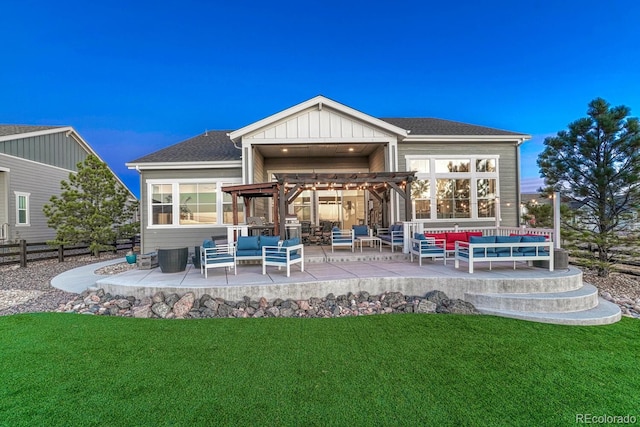 back of property featuring a lawn, an outdoor living space, and a patio